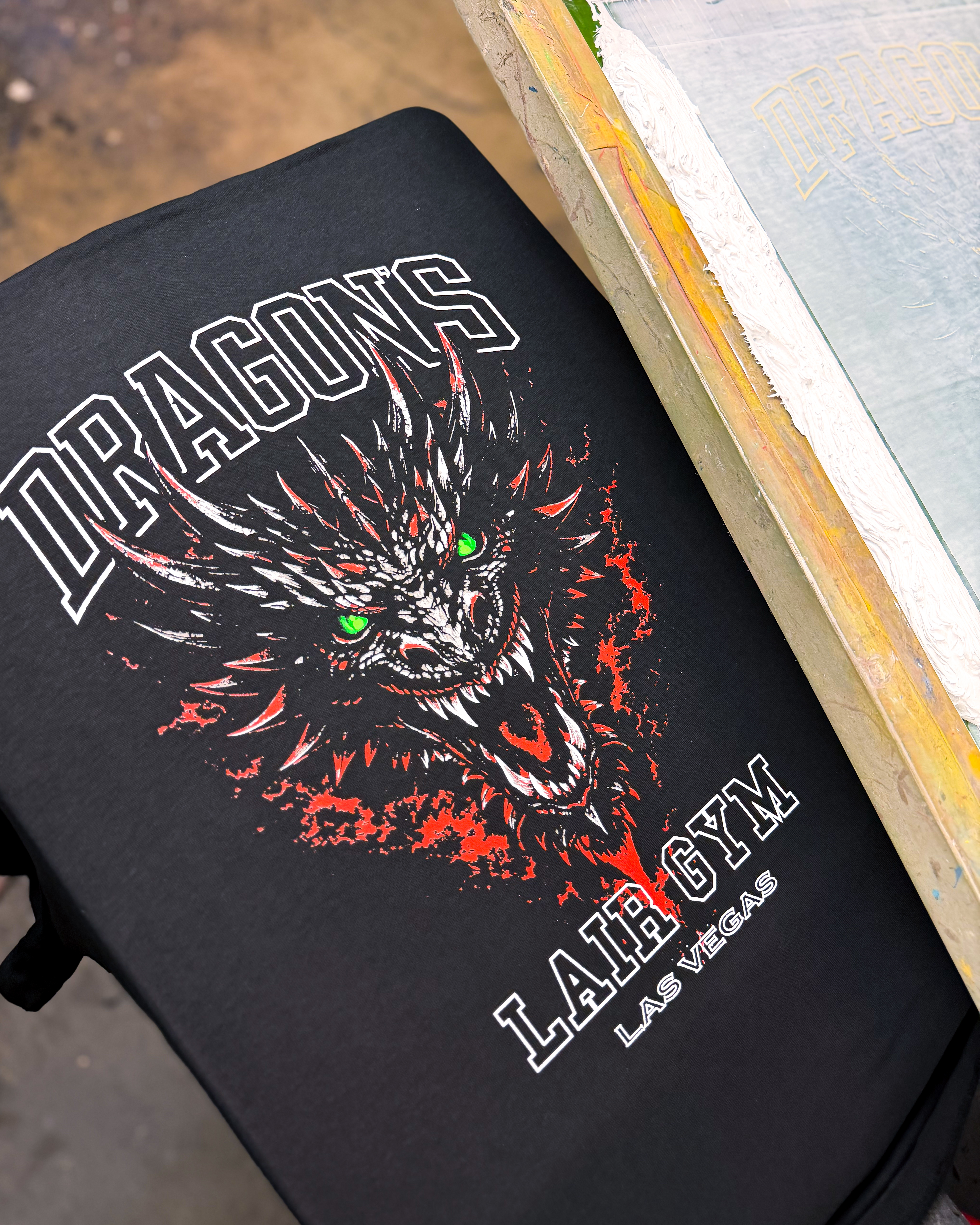 Black DLG Dragon gym shirt on a screen printing press
